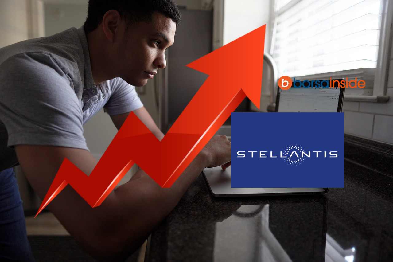trader in azione e grafico di rialzo con logo Stellantis blu