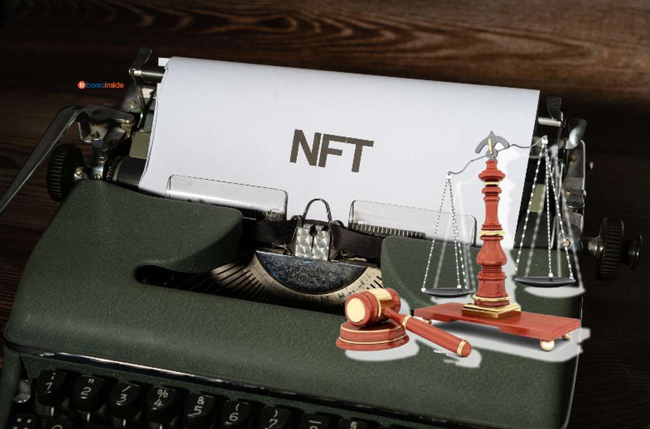 una macchina da scrivere da cui esce un foglio con la scritta NFT