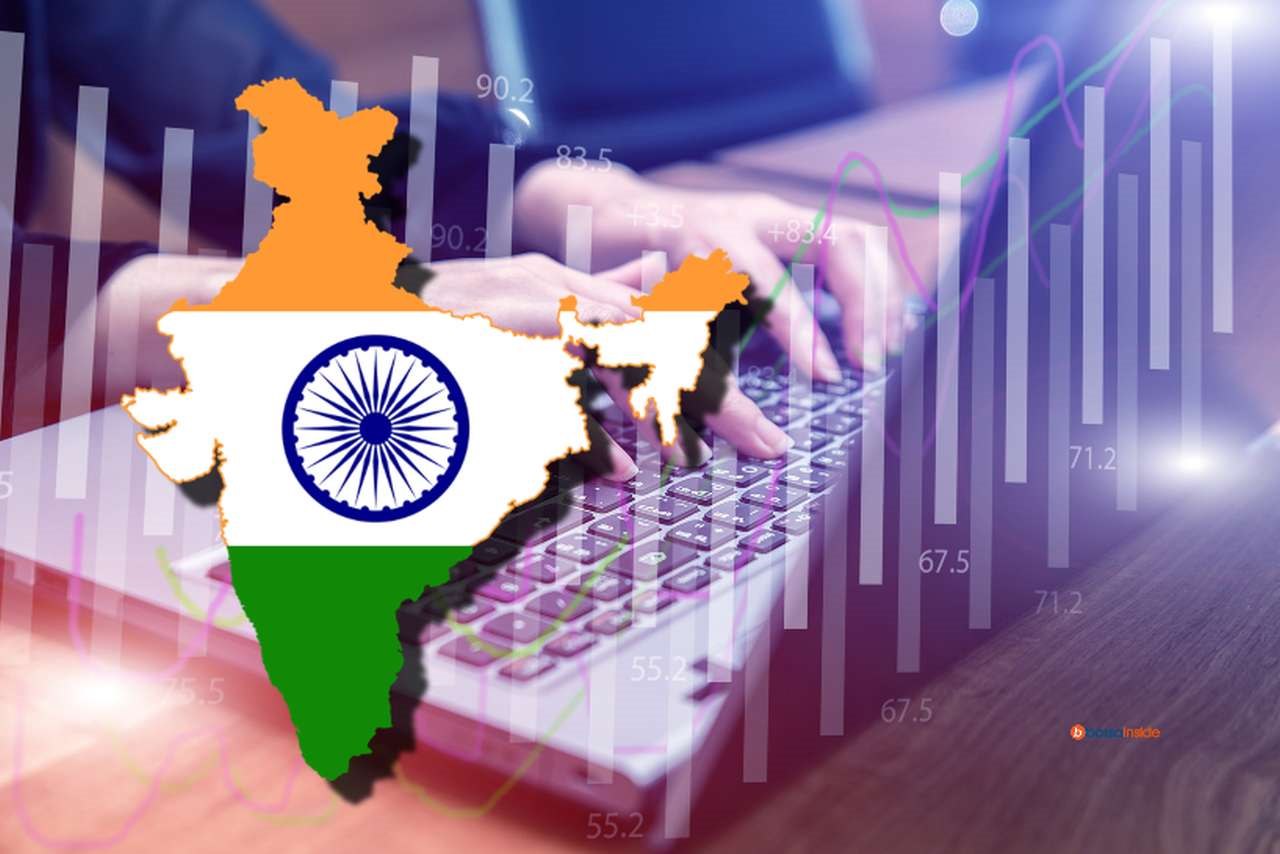 Un laptop con un grafico a candele in trasparenza e la bandiera dell'India, racchiusa nei confini dello Stato in sovrimpressione