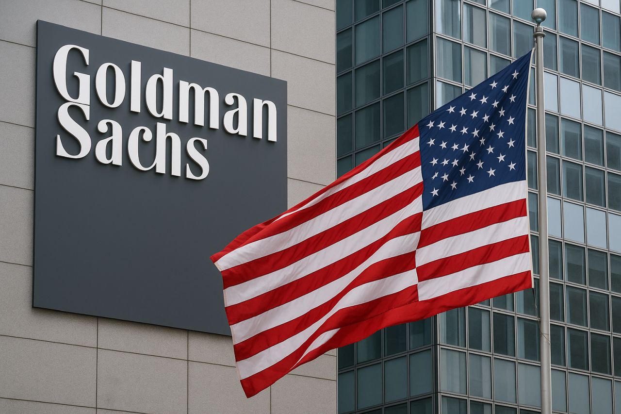 Un edificio con l'insegna Goldman Sachs e la bandiera degli USA davanti